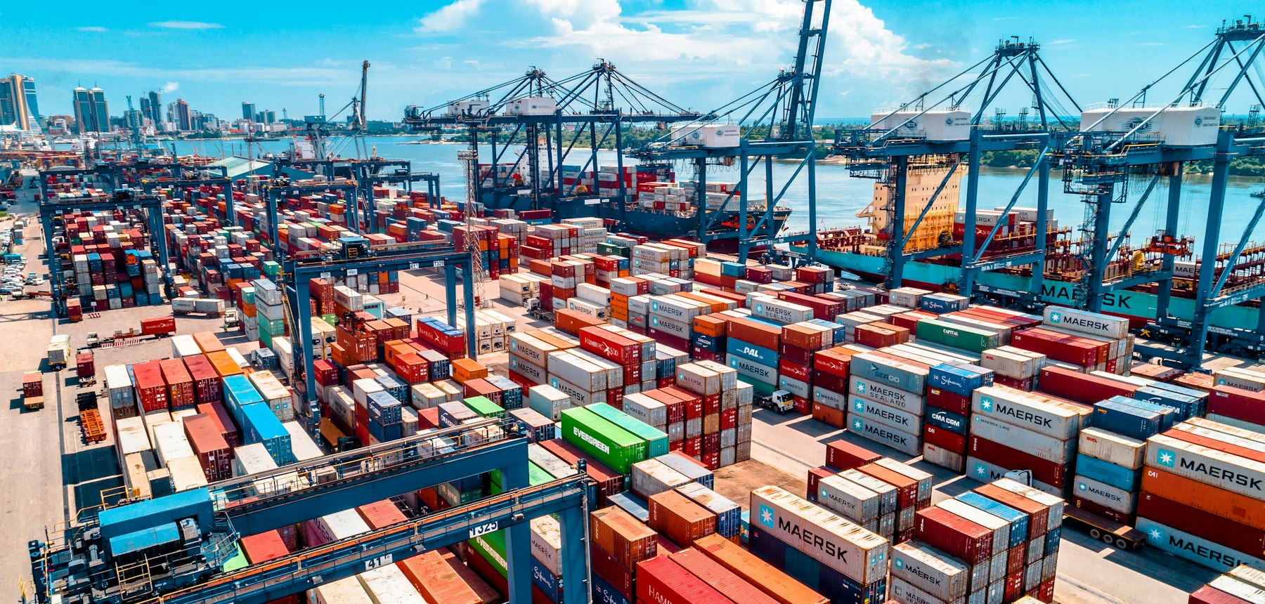 Container terminal with cranes and stacked shipping containers